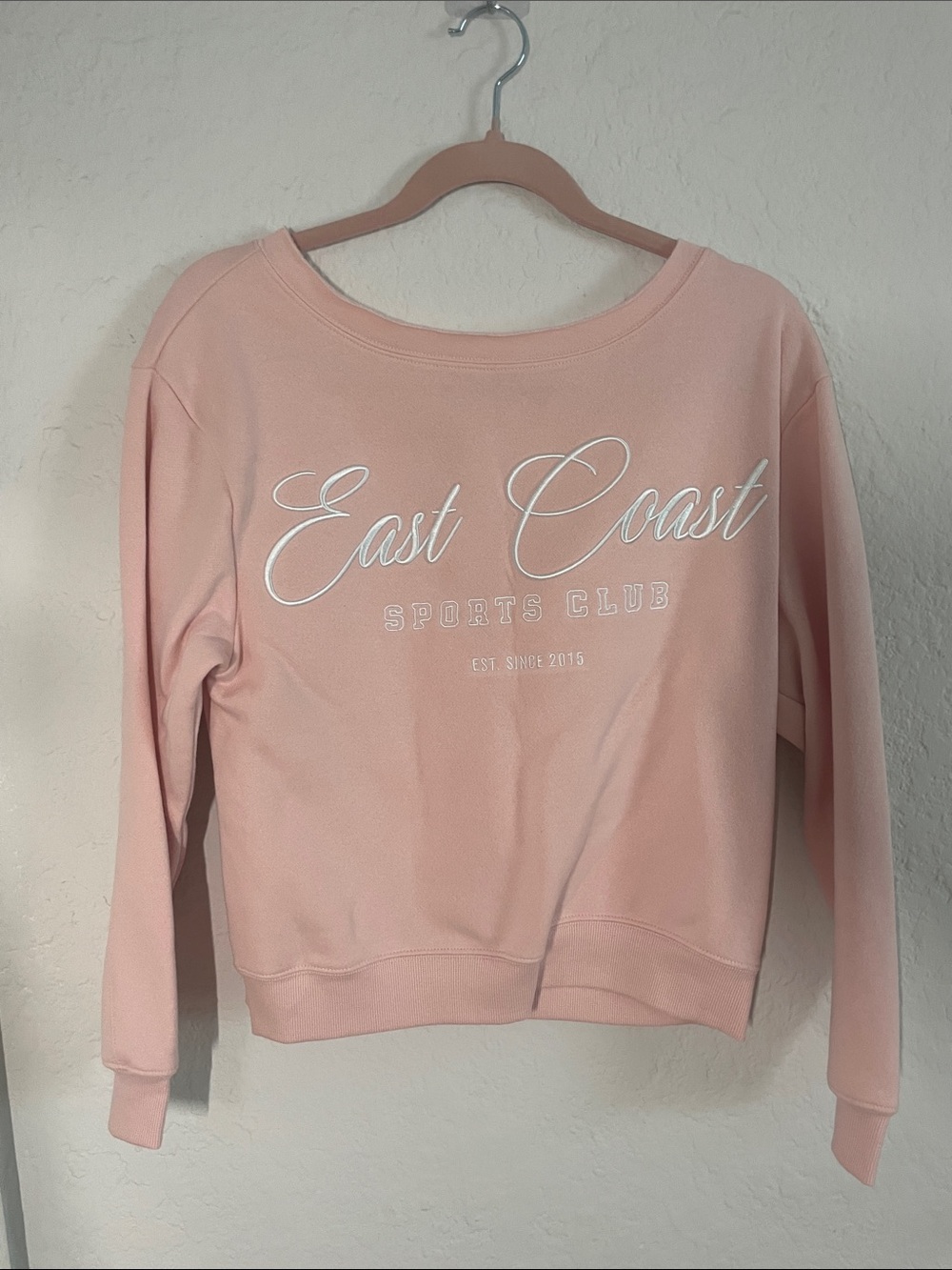 light pink embroidered east coast sports club off the shoulder jacket. size XL.